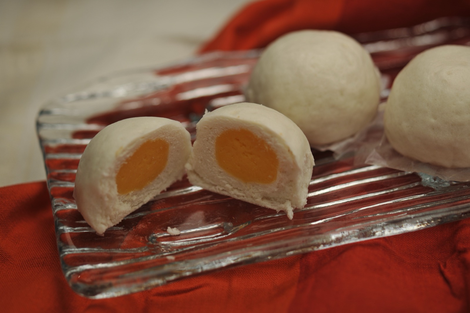 Custard bun cut open showing golden custard filling
